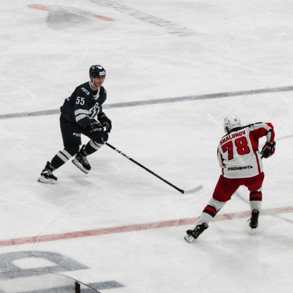 Defenseman closing the gap on a puck carrier